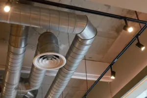 HVAC ducting system wrapped around ceiling lights.