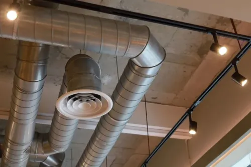 HVAC ducting system wrapped around ceiling lights.