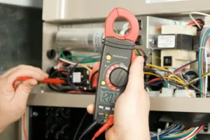 An HVAC specialist calibrates a diagnostic tool for an AC repair.