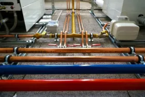 An HVAC expert shows off their optimum line placements in this medium wide shot.