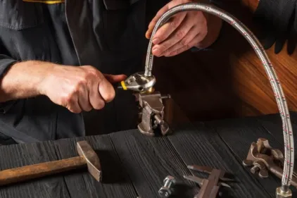 An HVAC expert assembles components with a wrench.