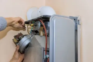 An HVAC specialist tests components on a new emergency furnace replacement installation.