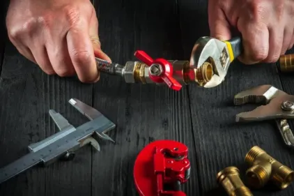 An HVAC expert assembles a valve for a hose.