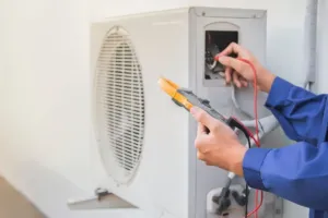 AC repair experts checking on the electronics of a new unit.
