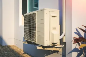 An AC repair company displaying an older model ductless mini split system they replaced.